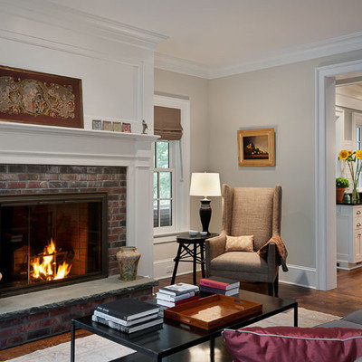 Living room - traditional enclosed living room idea in New York with beige walls, a standard fireplace, a brick fireplace and no tv