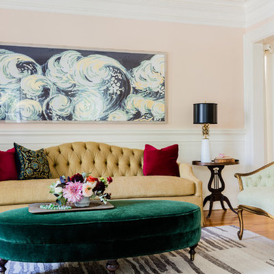 Elegant formal medium tone wood floor living room photo in Boston with pink walls and no tv