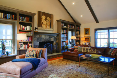 Example of a country living room design in New York with a stone fireplace
