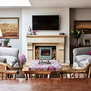 Inspiration for a farmhouse open plan living room in Wiltshire with white walls, a wood burning stove and a wall mounted tv.