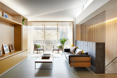 Cette photo montre un salon tendance de taille moyenne avec un mur blanc, un sol en linoléum et un téléviseur encastré.