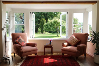 Inspiration for a traditional enclosed living room in Kent with a reading nook, beige walls and dark hardwood flooring.