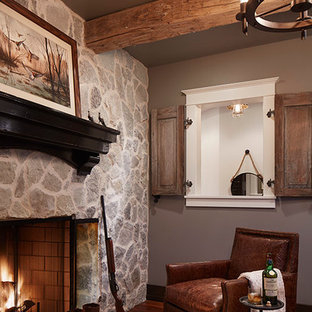 Inspiration for a transitional medium tone wood floor living room remodel in Minneapolis with brown walls, a standard fireplace and a stone fireplace