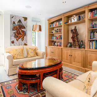 This is an example of a medium sized world-inspired living room in London with a reading nook, white walls, medium hardwood flooring and brown floors.