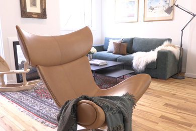 Medium sized scandi open plan living room in Philadelphia with white walls, medium hardwood flooring, a two-sided fireplace, a wall mounted tv and brown floors.