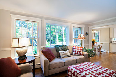 Inspiration for a mid-sized transitional open concept medium tone wood floor living room remodel in Portland Maine with beige walls, no fireplace and a media wall