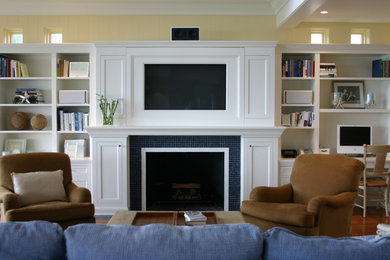 Example of a classic living room design in New York with a tile fireplace and yellow walls