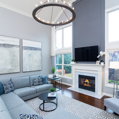 Inspiration for a mid-sized transitional open concept dark wood floor and brown floor living room remodel in Detroit with gray walls, a standard fireplace, a stone fireplace and a wall-mounted tv