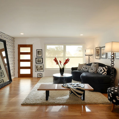 Living room - contemporary formal medium tone wood floor living room idea in Austin with no fireplace, no tv and black walls