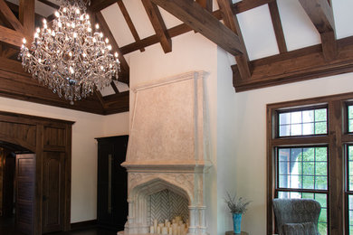 Imagen de salón abierto clásico extra grande con suelo de madera oscura, todas las chimeneas y marco de chimenea de piedra