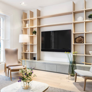 Photo of a medium sized scandinavian enclosed living room in London with white walls, light hardwood flooring, no fireplace, a wall mounted tv and brown floors.