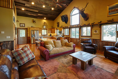 Mountain style open concept medium tone wood floor living room photo in Minneapolis with beige walls