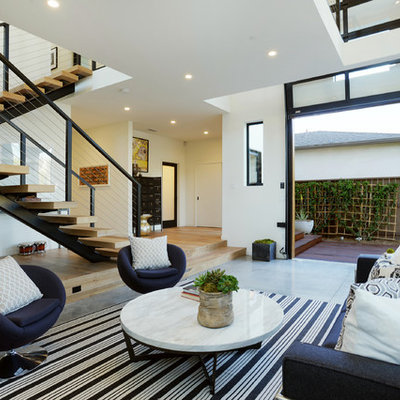 Inspiration for a contemporary concrete floor living room remodel in Los Angeles with white walls