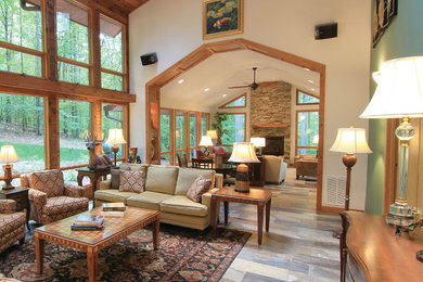 Large mountain style living room photo in Raleigh with beige walls and a stone fireplace