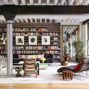 Example of a large trendy light wood floor living room library design in New York with no fireplace and no tv