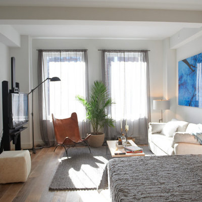 Example of a mid-sized trendy formal and open concept medium tone wood floor living room design in New York with white walls
