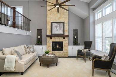 Example of a transitional ceramic tile living room design in Kansas City with gray walls and a stone fireplace