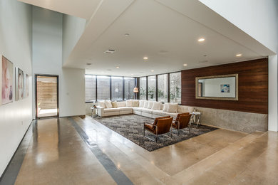 Example of a minimalist open concept concrete floor living room design in Dallas with white walls