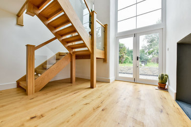 Oak open tread staircase with glass balustrade