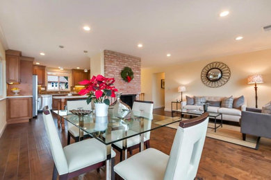 Living room - large modern formal and enclosed medium tone wood floor living room idea in San Francisco with yellow walls, a standard fireplace, a stone fireplace and no tv