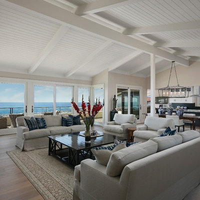 Large transitional open concept dark wood floor and brown floor living room photo in Santa Barbara with beige walls, a standard fireplace and a stone fireplace