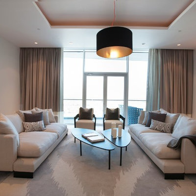 Example of a trendy living room design in Other with beige walls