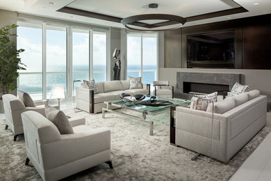 Living room - large contemporary formal and open concept marble floor and white floor living room idea in Miami with gray walls, a standard fireplace, a stone fireplace and a concealed tv