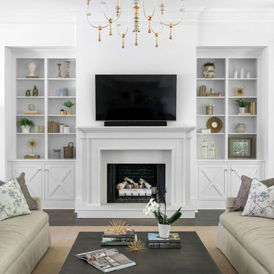 Inspiration for a large transitional open concept dark wood floor and brown floor living room remodel in Atlanta with white walls, a standard fireplace, a stone fireplace and a wall-mounted tv