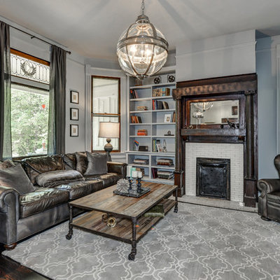 Example of a mid-sized classic enclosed dark wood floor living room library design in Atlanta with a standard fireplace, a tile fireplace and gray walls