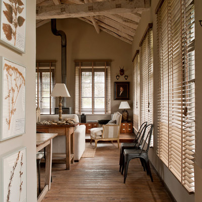Large country open concept medium tone wood floor living room photo in Bilbao with a wood stove