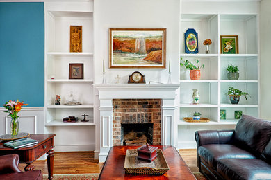 Example of a mid-sized classic open concept medium tone wood floor and brown floor living room design in DC Metro with beige walls, a standard fireplace, a brick fireplace and no tv