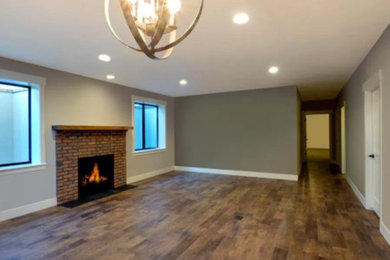 Example of a large transitional open concept dark wood floor living room design in Denver with gray walls
