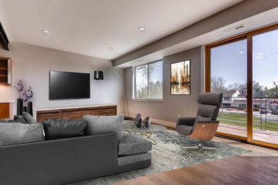 Photo of an expansive urban formal open plan living room in Denver with grey walls, dark hardwood flooring and a wall mounted tv.