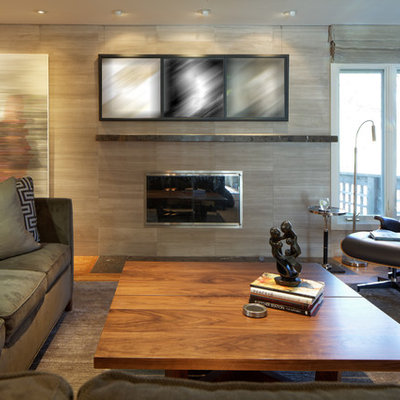 Living room - mid-sized contemporary enclosed carpeted and gray floor living room idea in Omaha with beige walls, a standard fireplace, a tile fireplace and no tv