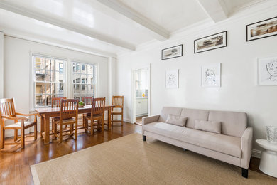 Photo of a large traditional formal open plan living room in New York with white walls and painted wood flooring.