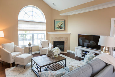 Medium sized classic open plan living room in Cincinnati with beige walls, dark hardwood flooring, a freestanding tv and a corner fireplace.