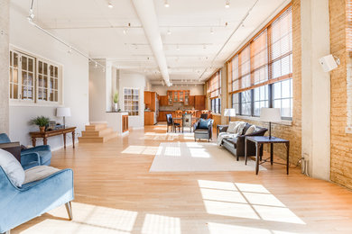 Living room - huge transitional open concept light wood floor living room idea in Milwaukee