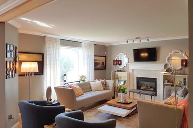 エドモントンにある高級な広いトランジショナルスタイルのおしゃれなLDK (グレーの壁、無垢フローリング、標準型暖炉、タイルの暖炉まわり、壁掛け型テレビ) の写真