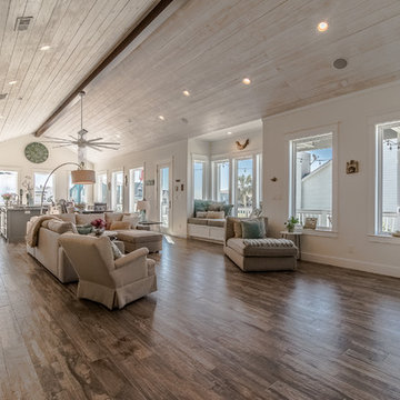 Open concept living area with shiplap ceiling and wood beam