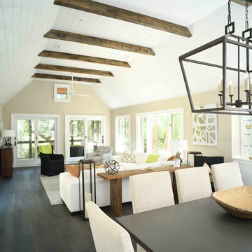 Open concept living space with wood beams and vaulted ceiling