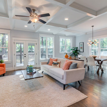 Open living & dining room with orange accents