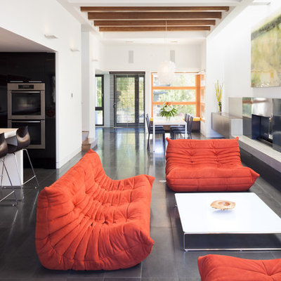 Example of a trendy open concept living room design in Vancouver with white walls
