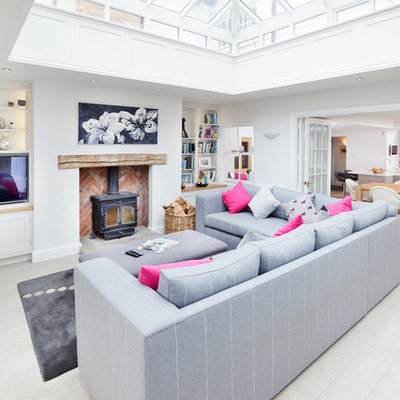 Huge trendy enclosed porcelain tile and beige floor living room photo in Other with white walls and a wood stove