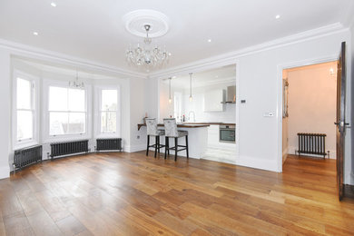 This is an example of a large modern formal enclosed living room in London with grey walls and dark hardwood flooring.