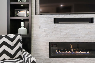 Inspiration for a large transitional vinyl floor and gray floor living room remodel in Kansas City with gray walls, a ribbon fireplace and a tile fireplace