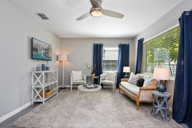 На фото: гостиная комната в стиле шебби-шик с серыми стенами, полом из керамической плитки и серым полом без камина с