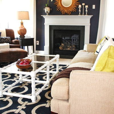 Transitional living room photo in Charlotte with blue walls and a standard fireplace