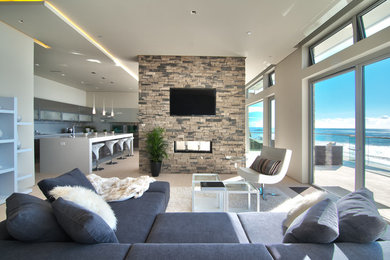 Large trendy open concept light wood floor and beige floor living room photo in Chicago with gray walls, a two-sided fireplace, a stone fireplace and a wall-mounted tv