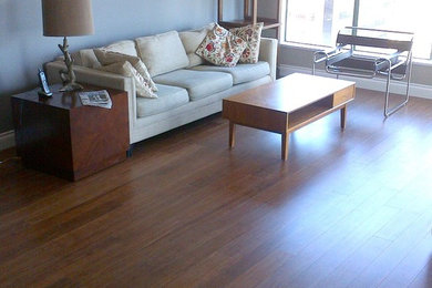 Inspiration for a large timeless open concept medium tone wood floor living room remodel in Vancouver with white walls