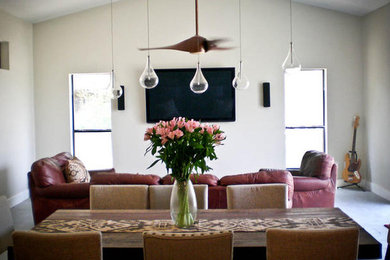 Example of a mid-sized trendy slate floor and gray floor dining room design in Austin with white walls and no fireplace